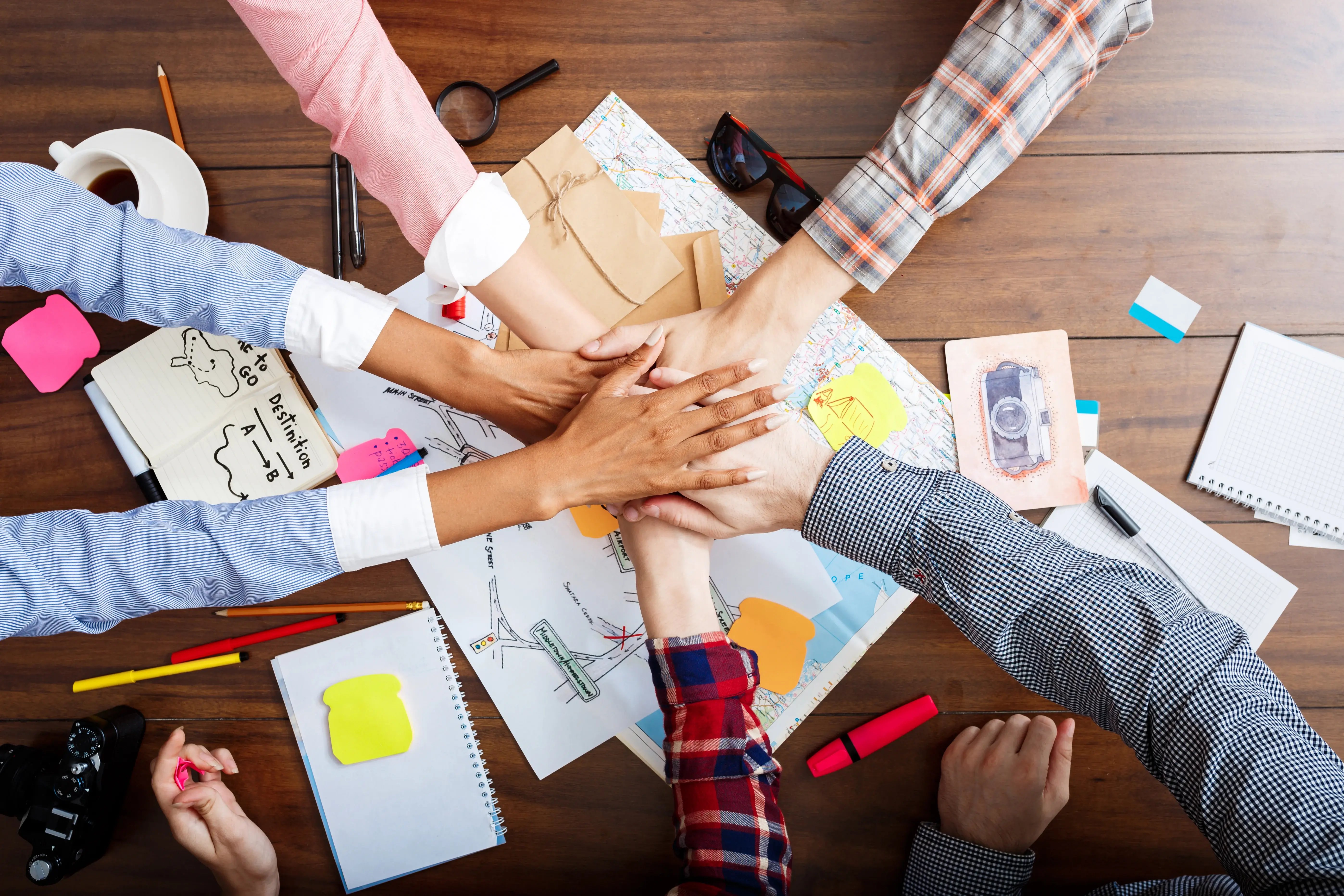 businessmen-hands-wooden-table-with-documents-drafts