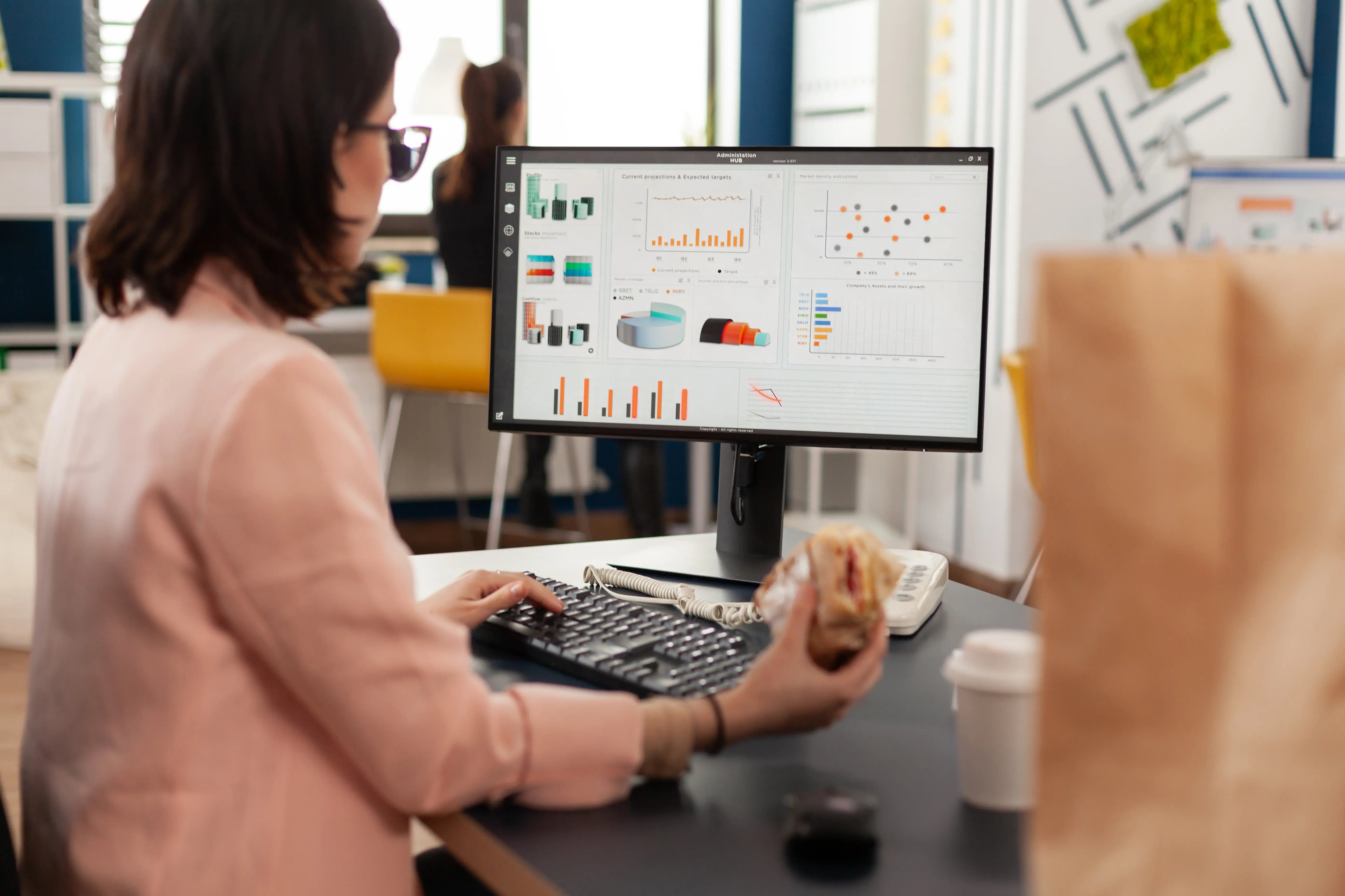 businesswoman-eating-tasty-sandwich-having-meal-break-working-business-company