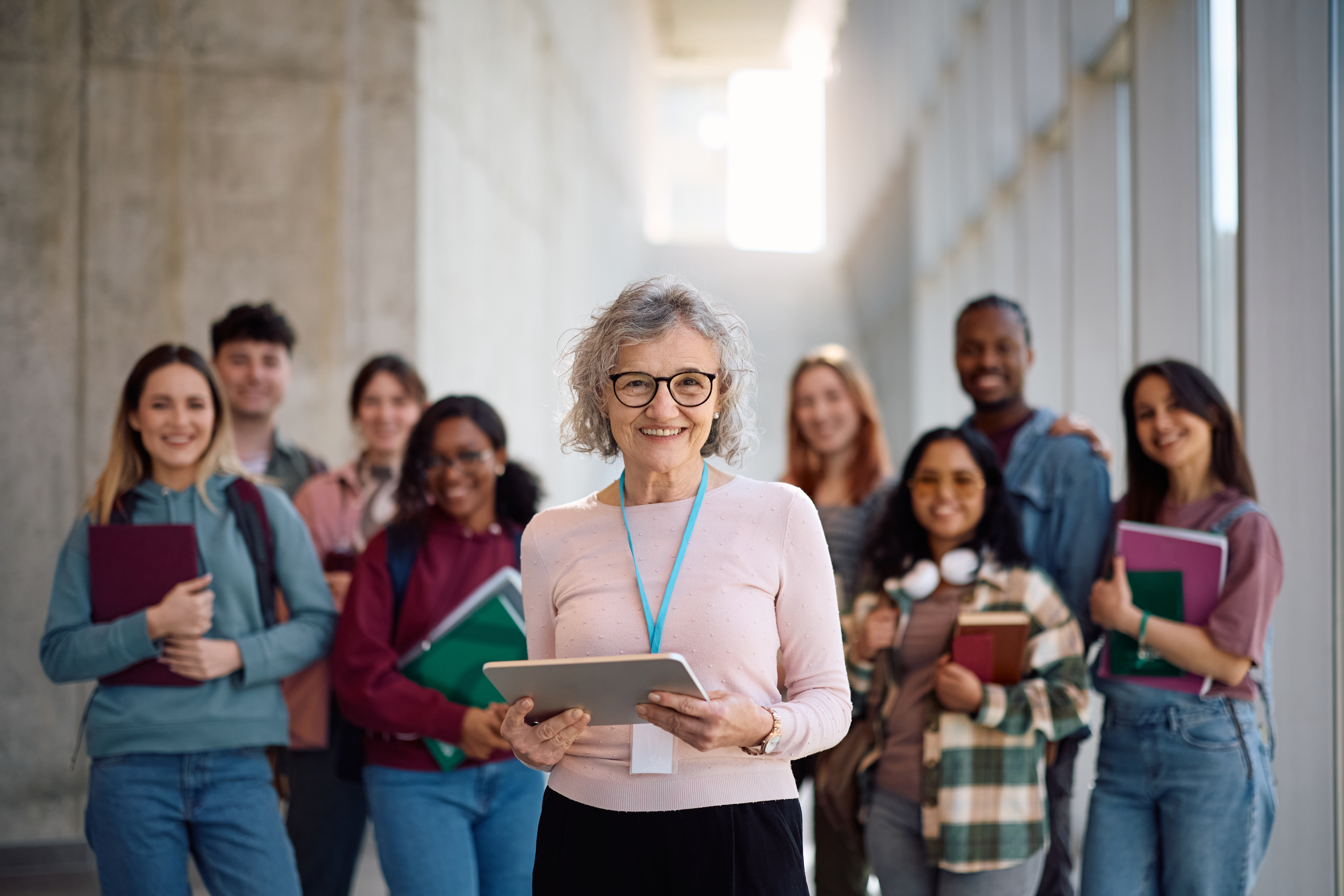smiling-teacher-with-students-in-school-hallway-2026-09-22-05-42-15-utc