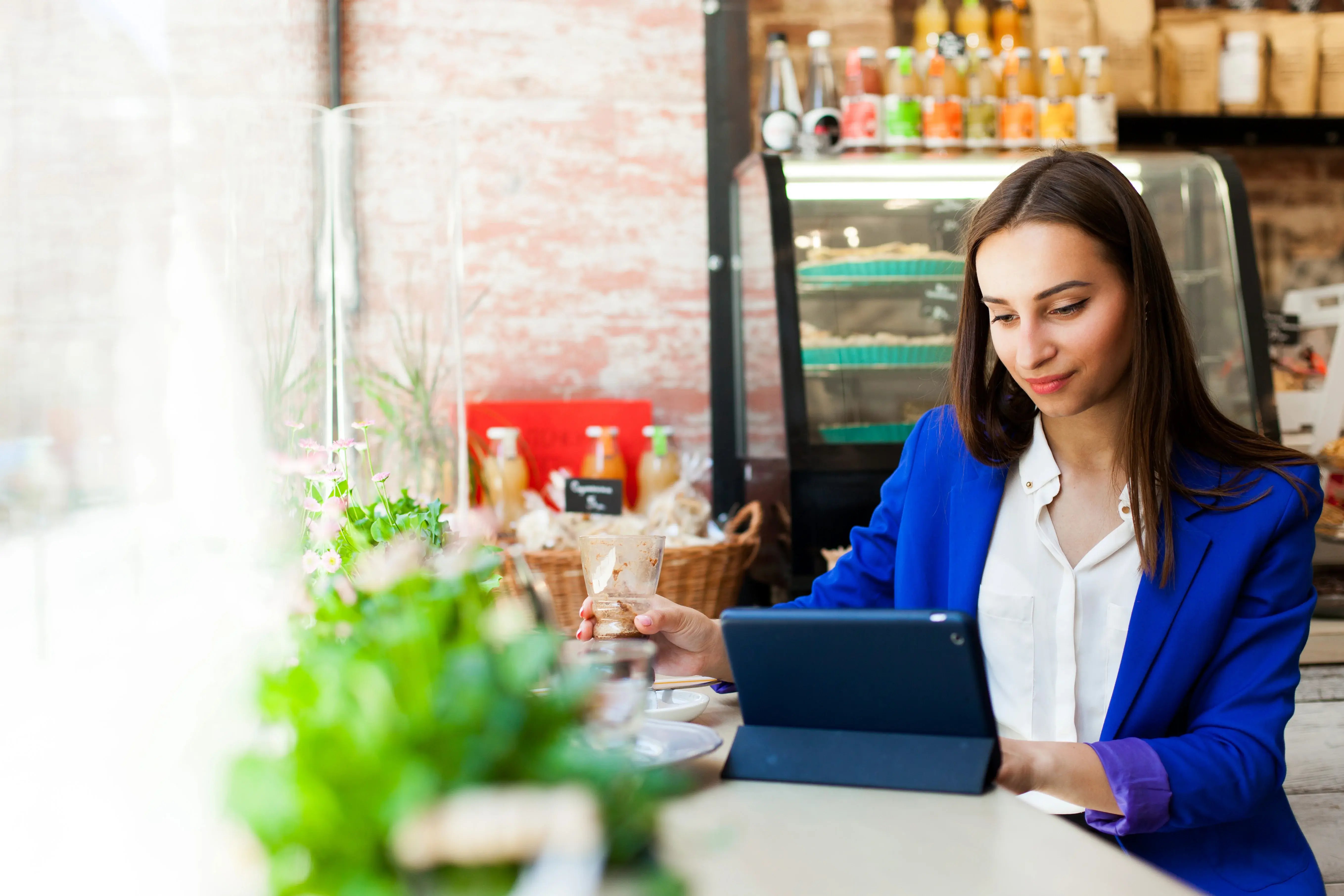 woman-works-with-tablet-table-cafe